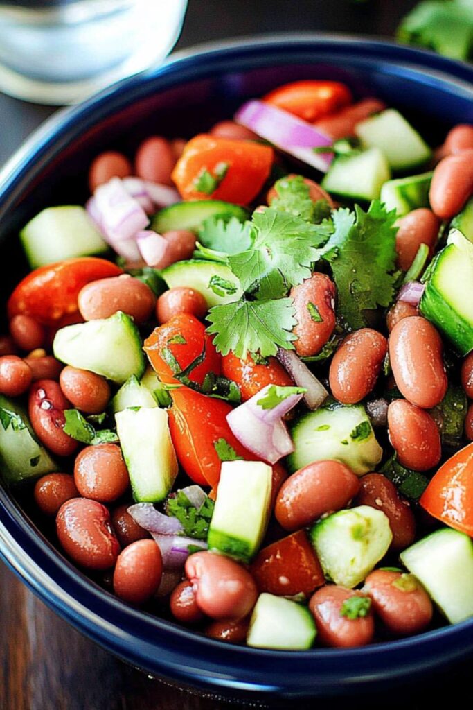 A refreshing kidney bean salad with cucumber and tomato, ideal as picnic side dishes.