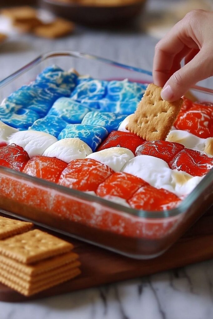 Baked s'mores dip with colored marshmallows arranged to resemble an American flag.