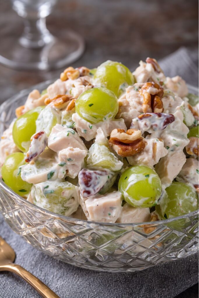 Ina Garten chicken salad with roasted chicken, green grapes, toasted walnuts, and pecans mixed in a creamy dressing.