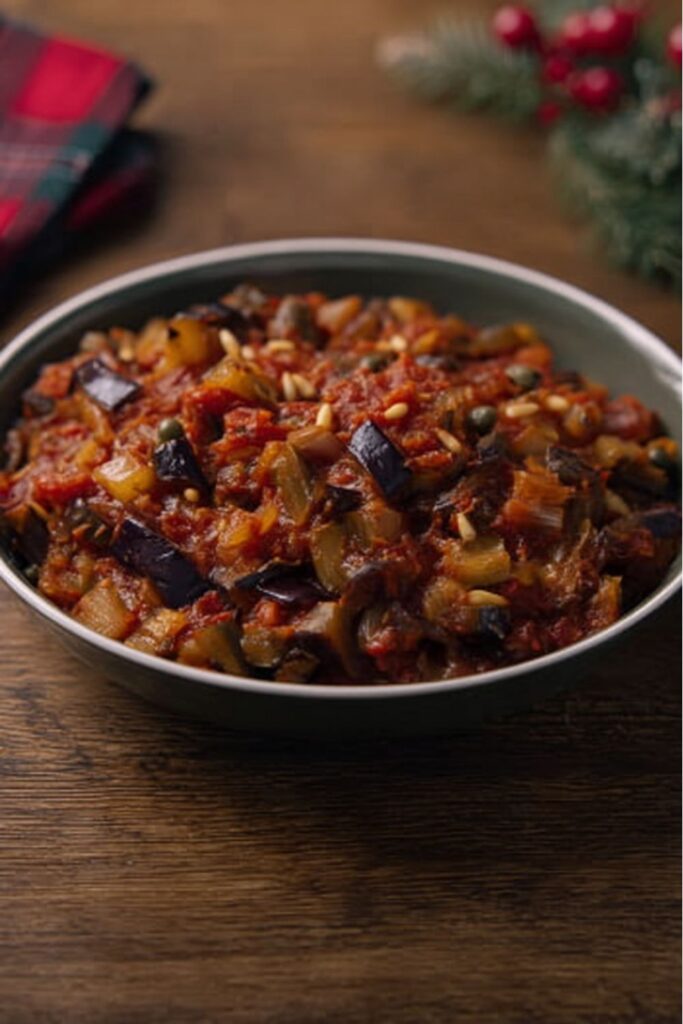 rich Sicilian eggplant caponata simmering with tomatoes, capers, and pine nuts inspired by Stanley Tucci Christmas recipes
