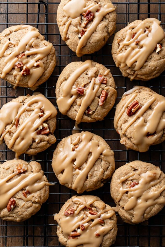 Soft maple pecan cookies drizzled with maple icing, arranged on a plate as cozy and sweet Thanksgiving school treats for kids.