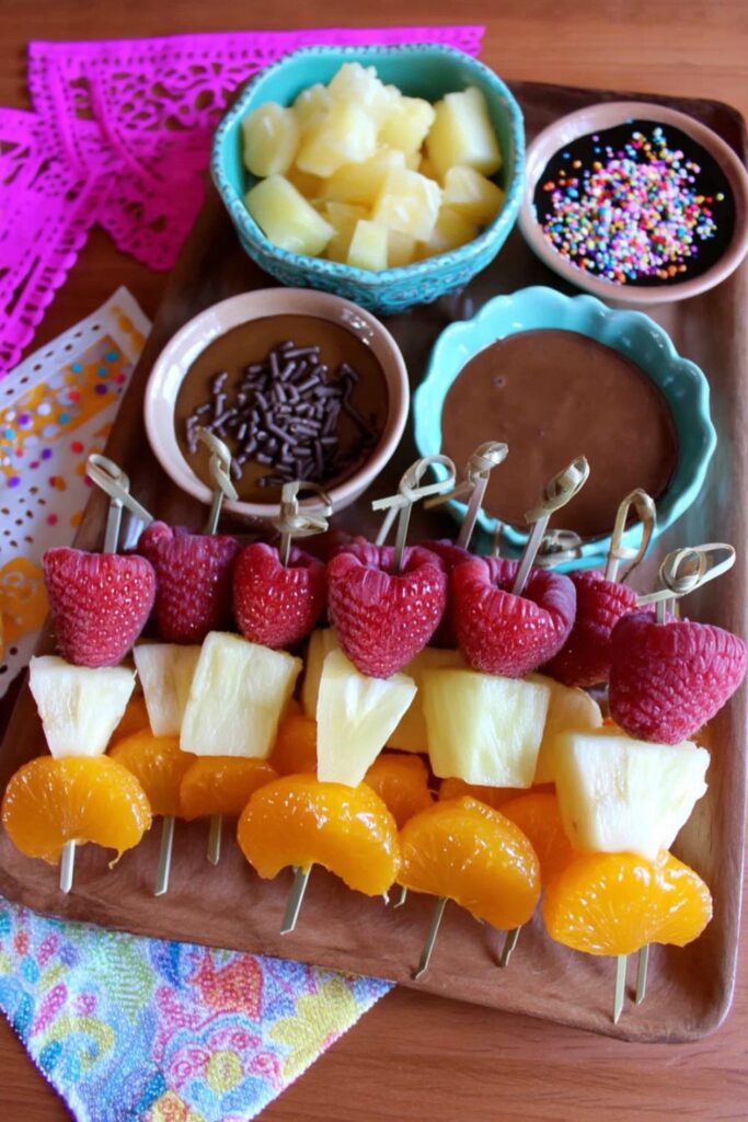 Colorful fruit skewers with chocolate dip, fun Finger Foods Easy Party treat for kids.