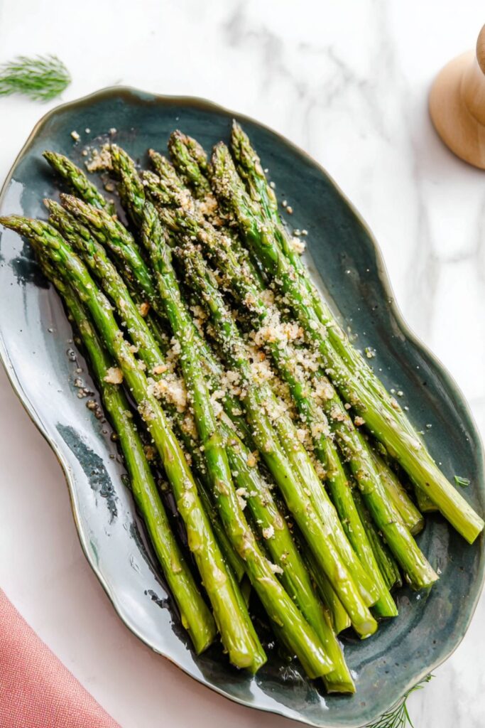 Roasted green asparagus spears topped with parmesan cheese and garlic, a tasty Mother's Day food.