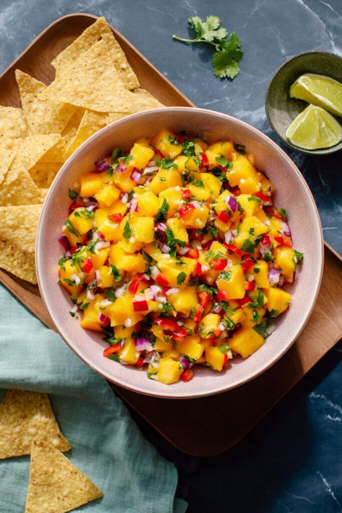 Fresh mango salsa with chips, bright fiesta appetizers option.