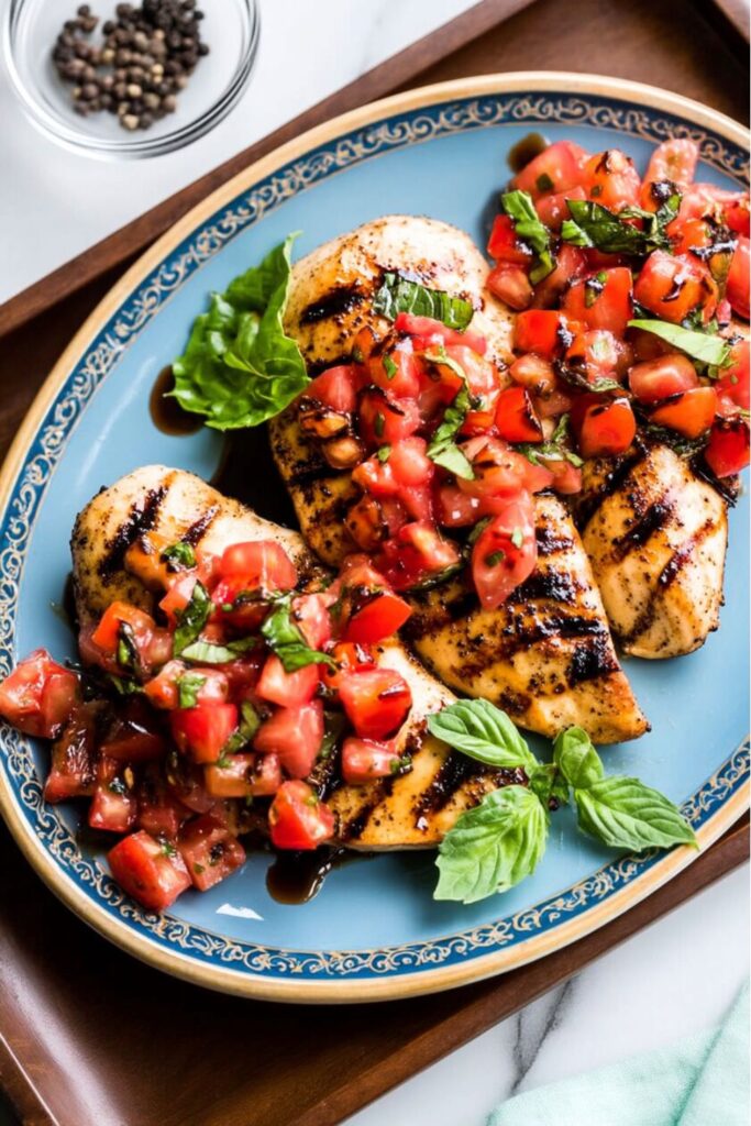Grilled chicken topped with fresh tomato bruschetta, a highlight for a Father’s Day Dinner BBQ.