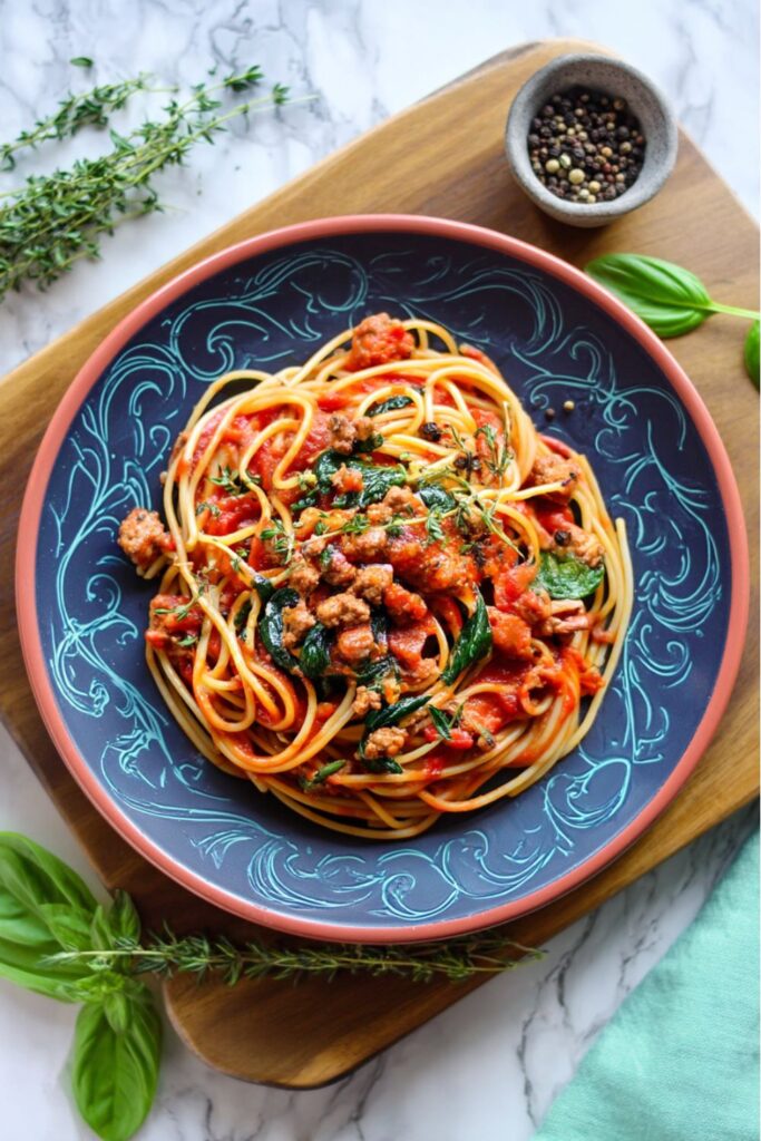 Hearty spaghetti with Italian sausage and fresh spinach, a top choice for Meals For Father's Day.