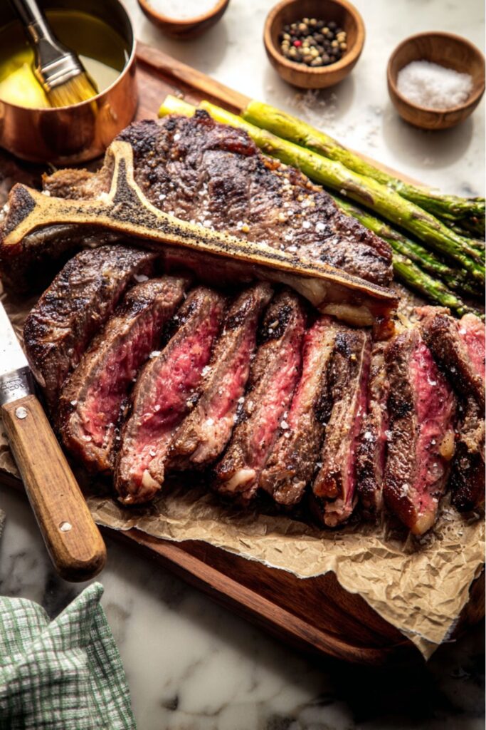 A sliced Porterhouse steak with asparagus, a prime choice for a Father’s Day Dinner.