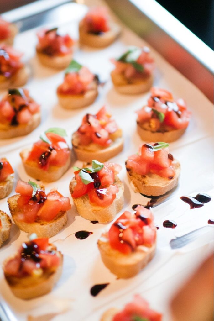 Crispy baguette slices topped with fresh diced tomatoes and basil for fourth of july easy snacks.