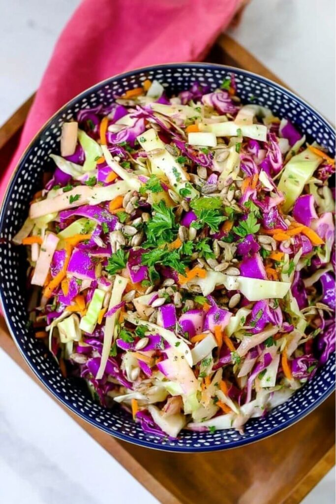 A vibrant bowl of purple and green cabbage slaw for Whole 30 4th Of July Food.