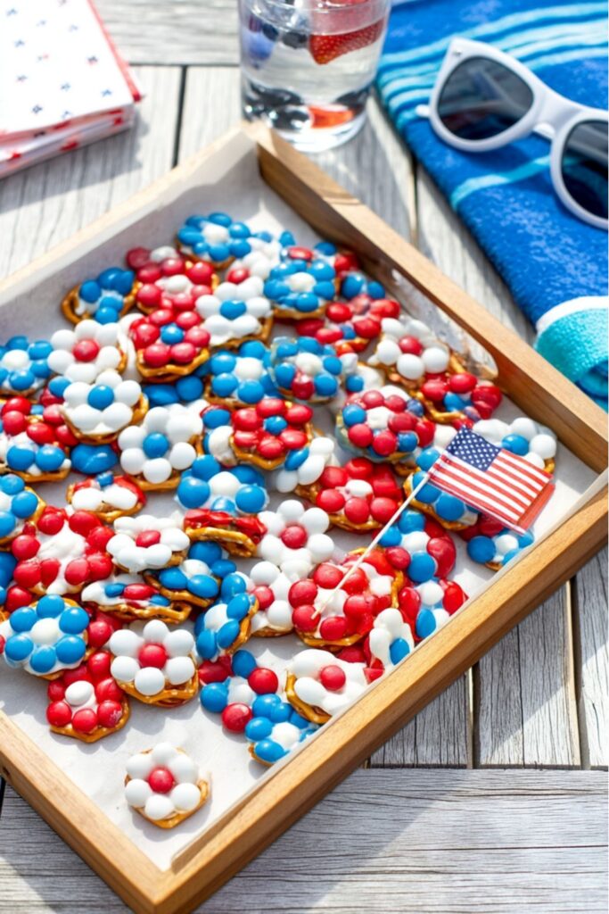 Patriotic daisy pretzel bites with red white and blue M&Ms on Kids Patriotic Party Snacks tray.