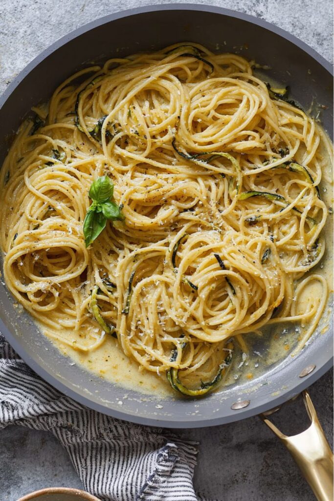 Creamy spaghetti with fried zucchini and melted cheese, a classic example of Italian main dishes.