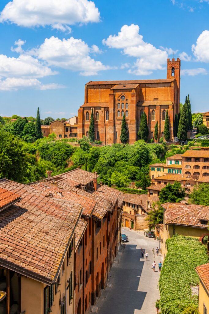 Siena brick cathedral above terracotta rooftops for Where to stay in Tuscany near historic streets