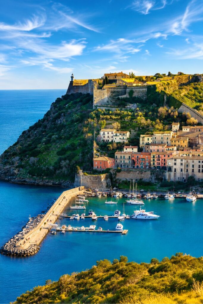 Tuscan Coast harbor, blue marina, and hilltop fortress for Where to stay in Tuscany by the sea