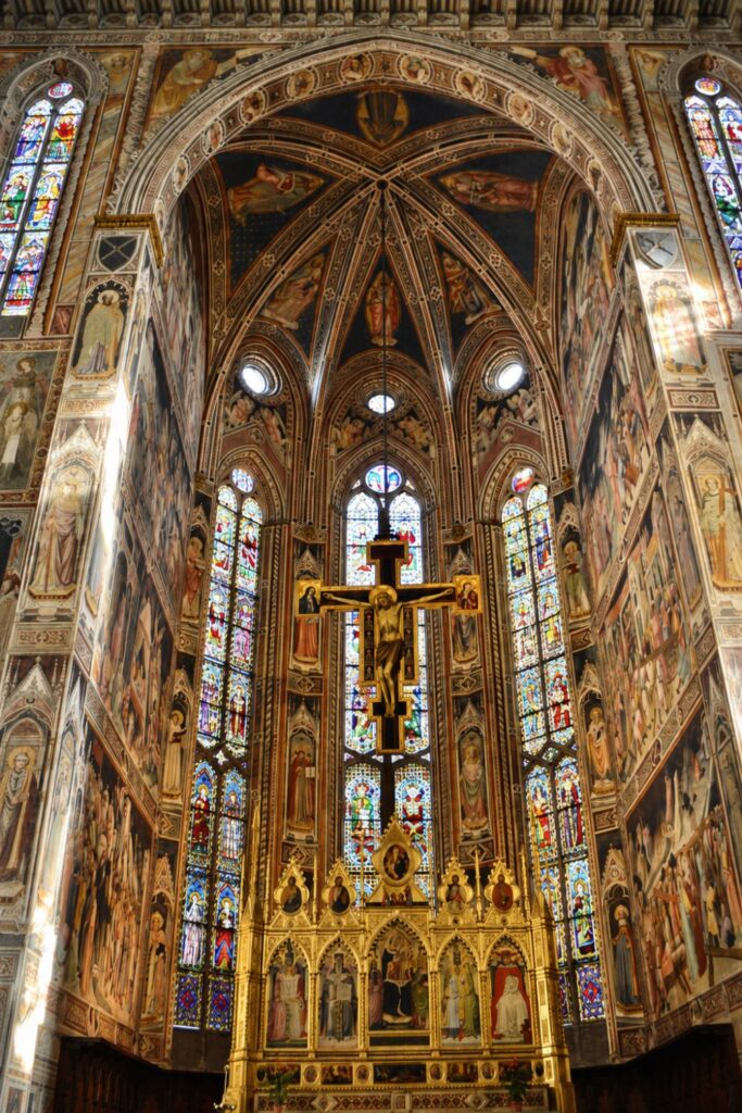 Frescoed Santa Croce chapel with stained glass, painted vaults, gilded altar, and crucifix