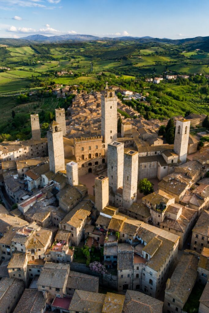 San Gimignano area towers over green hills for Where to stay in Tuscany countryside