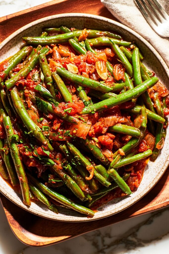 Tender green beans simmered in a rich garlic and crushed tomato sauce.